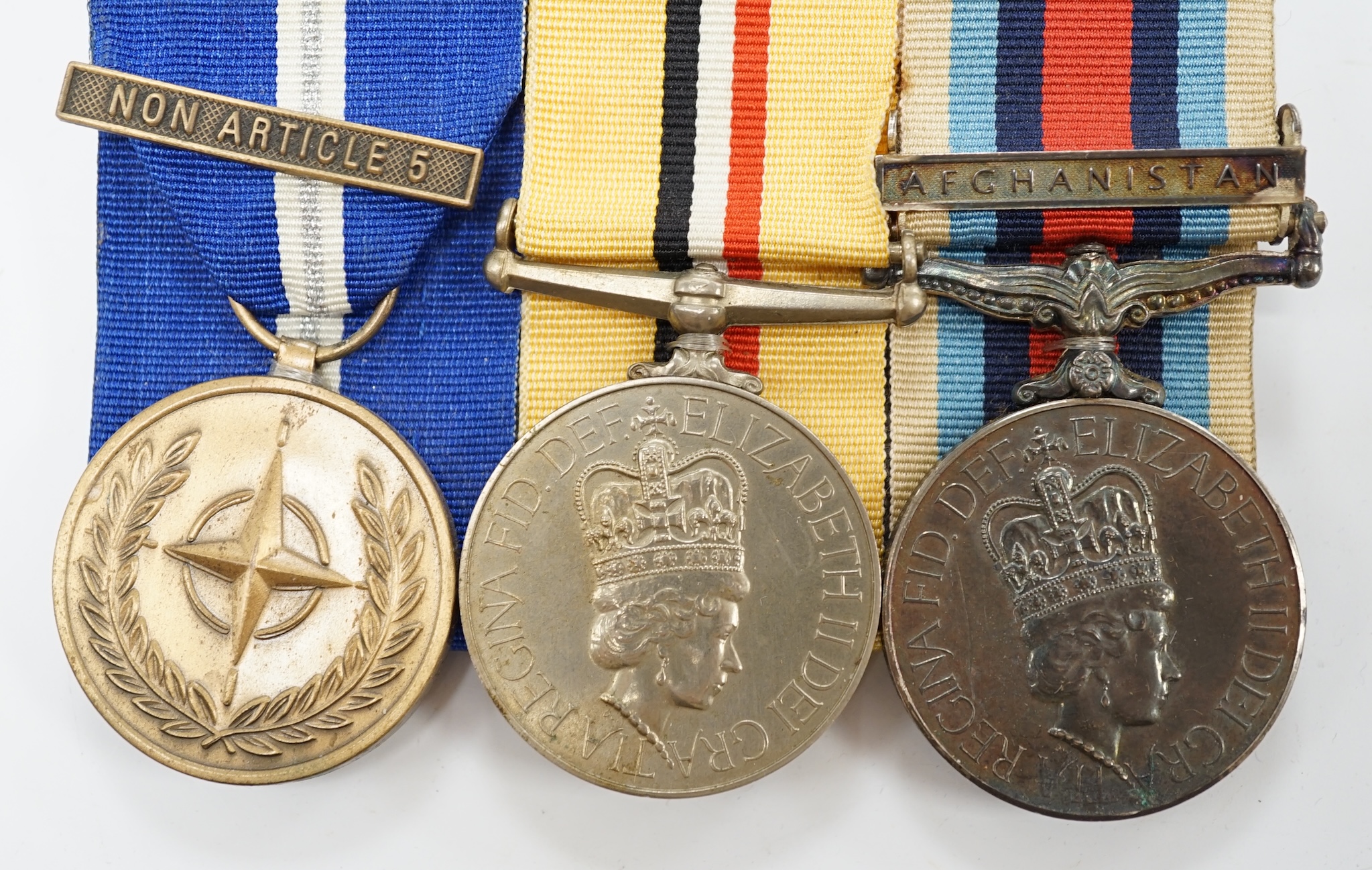 A Queen Elizabeth II medal group awarded to Signaller R.V. Johnson, Royal Signals, comprising; an Iraq Medal, an Operational Service Medal with a bar for Afghanistan and a UN Medal with a bar for Non Article 5, mounted t